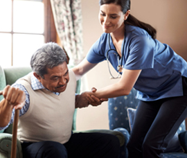 A healthcare professional helping a person stand